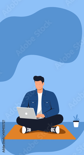 A focused man works remotely on his laptop, sitting comfortably on a mat with a minimalist blue background. Ideal for themes of productivity, online education, and modern flexible work lifestyles.