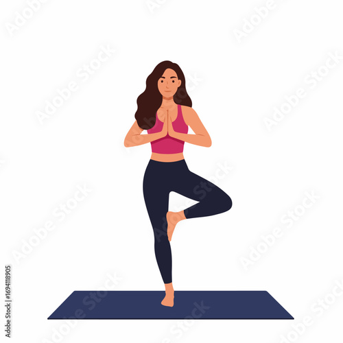 Woman practices Vrikshasana yoga pose for balance and mindfulness on mat