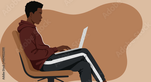 Young Black man focused on his laptop, working or studying remotely in a relaxed setting. Ideal for digital lifestyle, education, or business concepts.