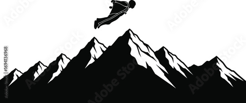 Silhouette of a wingsuit flyer soaring over jagged mountain peaks, a daring adventure in great outdoors