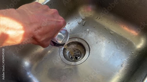 A can of beer or alcoholic or fizzy drink opened and poured down a stainless steel drink. Good for alcohol related material.