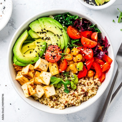 Colorful healthy bowl with quinoa, tofu, and vegetables