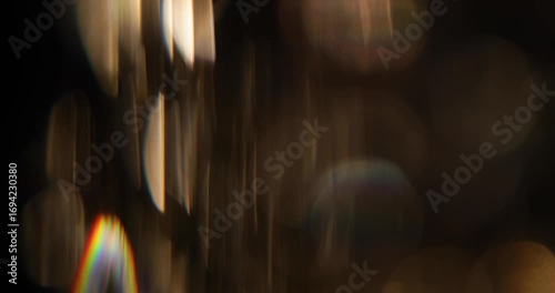 Abstract blurred light leaks on black background with copy space. Studio anamorphic lens flare bokeh effect.