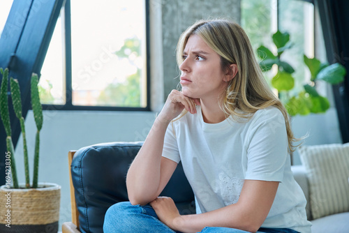 Unhappy upset tired young woman sitting in chair at home Free Download Unhappy upset tired young woman sitting in chair at home - GFXLoad