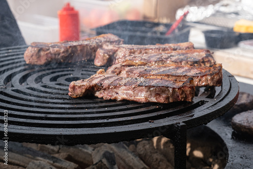 Grilled steaks at street food festival with chef in background