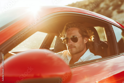 handsome confident man driving a red luxury sportscar on a coastal road, sunglasses, elegant casual outfit, golden hour lighting