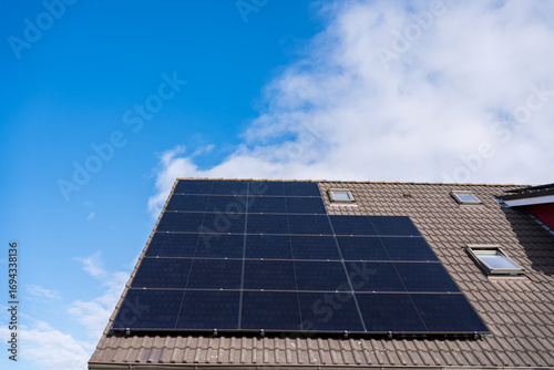 Wallpaper Mural Black solar panels on modern house roof Torontodigital.ca