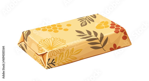 Rectangular object wrapped in patterned paper with floral and leaf designs in yellow, orange, and brown tones.