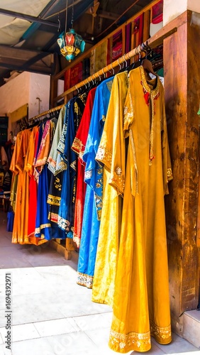 Colorful traditional dresses hanging on display