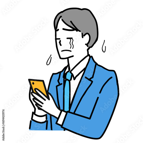 スマホを見て泣いているスーツ姿の若いビジネスマン