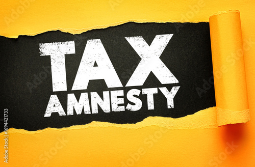 Photography Torn paper design reveals the bold distressed text Tax Amnesty