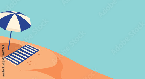 Beach scene featuring a striped beach towel and blue and white umbrella on sandy beach perfect for