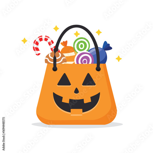 Orange pumpkin bucket filled with colorful candies and candy cane halloween trick or treat