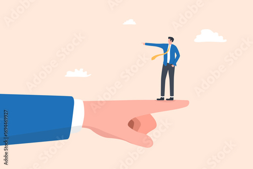 Businessman Standing on Giant Hand Pointing Right While Pointing Left, symbolizing disagreement, opposite direction, or conflict in business decisions.