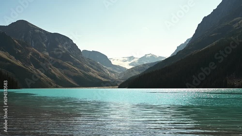 Peyto Lake near Banff with blue-green water rippling in a light wind, mountains in the background

