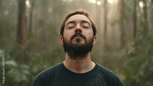 Serene Man with Closed Eyes in Lush Forest Setting Embracing Nature's Calmness and Tranquility Perfect for Meditation and Relaxation Themes