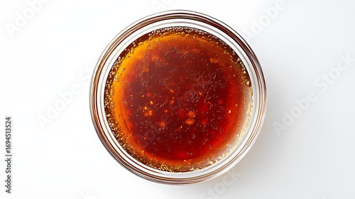 A top view of a glass bowl containing a dark red liquid with particles