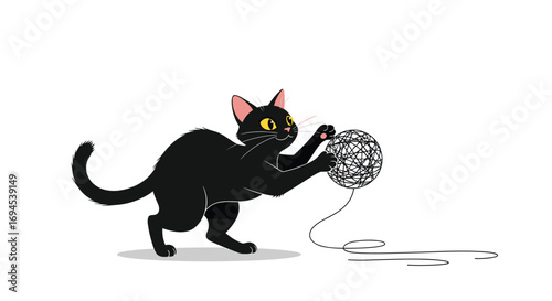 Adorable black cat happily playing with a tangled ball of yarn and string on a white background