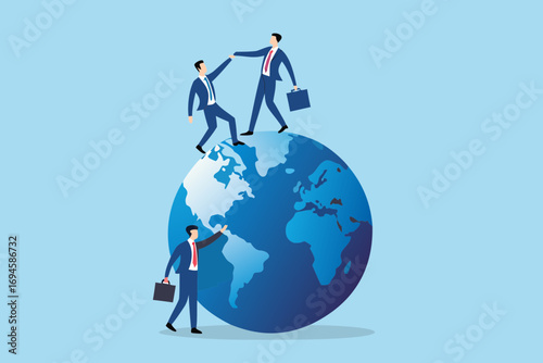 Businessmen collaborating on a globe representing global teamwork and international business success