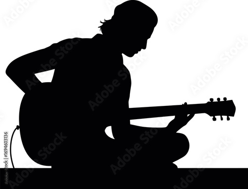 Silhouette of a musician playing guitar sitting down