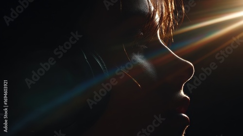 Dramatic Profile Portrait with Lens Flare and Chiaroscuro Lighting