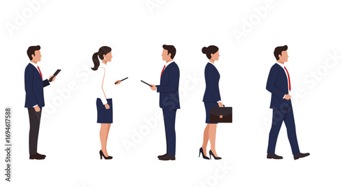 Business professionals in formal attire using digital devices and walking