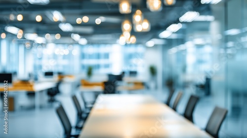 Blurred background of a modern office interior with bokeh lights and open workspace for corporate or business concepts
