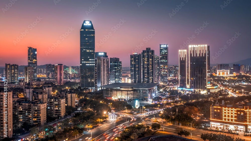 Fototapeta premium Huizhou Jiangbei CBD Skyline at Twilight - Aerial View of Illuminated Skyscrapers and Urban Cityscape
