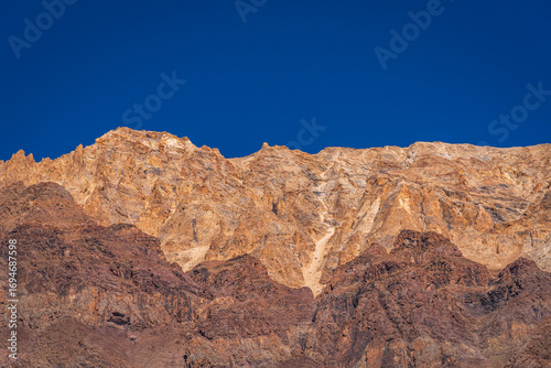 Barren cold desert mountain landscape adjacent to Chandrataal lake of Lahaul and Spiti mountain valley located high in rain shadowed region of Himalayas in Himachal Pradesh, India.