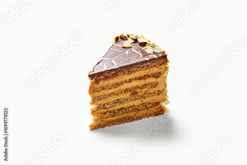 Delicious slice of layered mocha cake with chocolate frosting and almond flakes