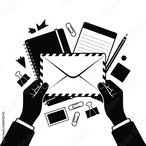 Hands holding an envelope surrounded by office supplies and stationery