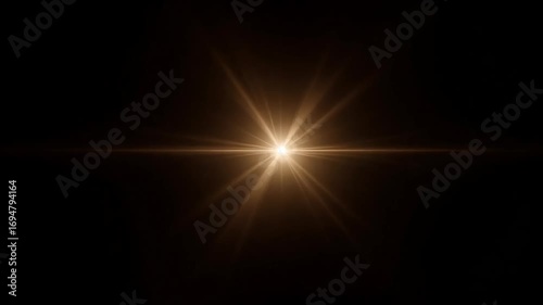 Bright golden starburst lens flare emanating from a central light source against a dark background