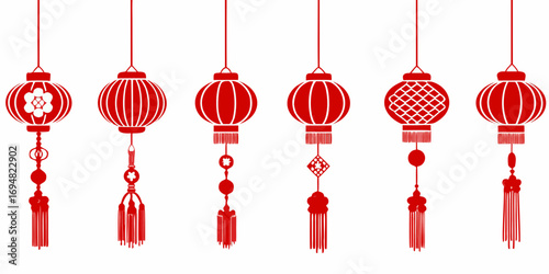 Collection of traditional red chinese lanterns with decorative tassels hanging against a white background