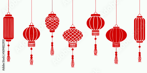 A collection of traditional red chinese lanterns with tassels hanging against a white background