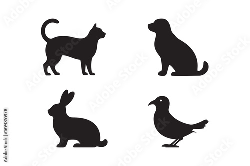 Silhouettes of a cat dog rabbit and bird on a white background