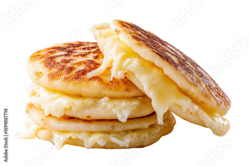 Stack of golden brown arepas stuffed with melted white cheese isolated on a transparent background food