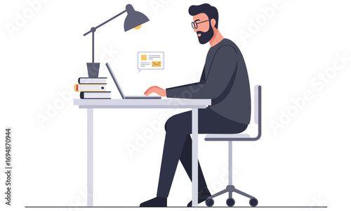 A businessman is working on a laptop while sitting at his desk in an office