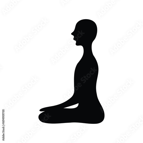 Silhouette of a person in lotus position meditating or practicing yoga and mindfulness