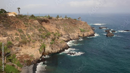 Breathtaking View of Playa de Castro in Los Realejos during Summer Day. Outdoor Scenery of Rocky Beach in Tenerife. Beautiful Landscape with Atlantic Wavy Ocean in Canary Islands.