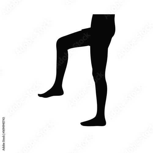 Black silhouette of a person standing with one knee raised high