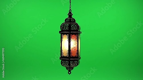 Ornate lantern glowing softly against a vibrant green screen backdrop with warm inviting ambiance for festive projects