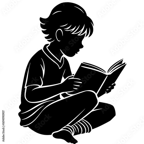 Silhouette of a child sitting cross-legged and reading a book with focused attention learning education