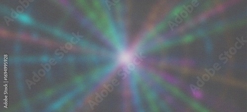 Abstract explosion of colorful light rays emanating from a bright center against a dark background 