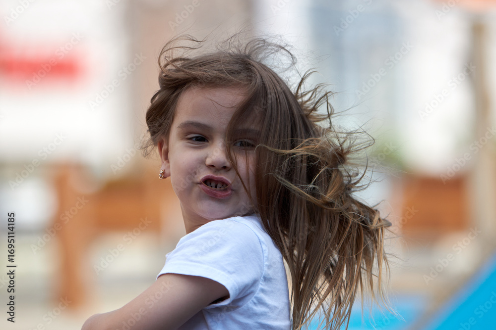 Fototapeta premium Little girl enjoying outdoor playtime
