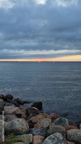 The Tranquil Sunset Casts a Gentle Glow Over the Serene Waters of the Coastal Landscape