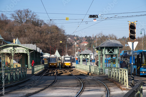 Tram station with trams and buses at suburban stop. Budapest, Hungary. Jan 2022.