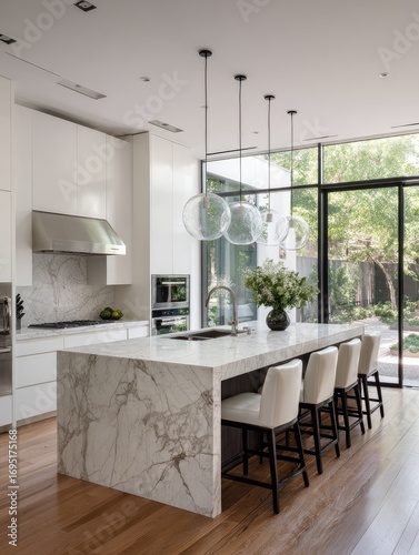 Modern white kitchen with marble island, patio view