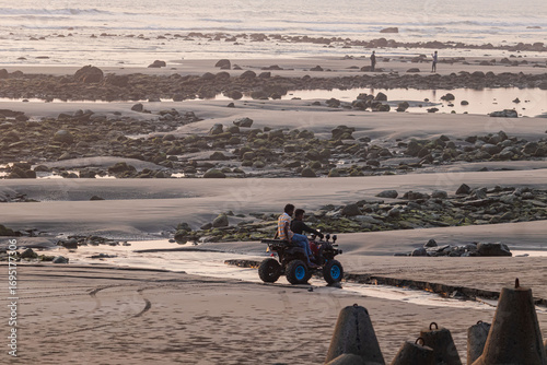 Thrilling coastal ride past shimmering tide pools reflecting orange twilight sky.
