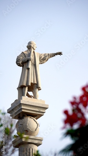 Monument honoring Christopher Columbus, pointing towards the new world with a globe below, located in the Canary Islands where he stopped before crossing the Atlantic