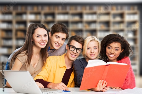 Happy students friends learning in library for education